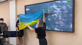 Ukraine protesters cover screen playing military propaganda outside Russian Embassy in Bangkok