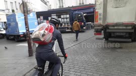 Paris cyclist spotted carrying his cat in a transparent backpack along Rue de la Roquette