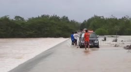 Motorcycle rider swept away by floods rescued by brave passers-by in southern Thailand