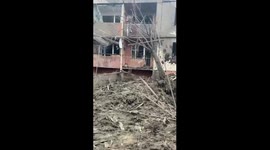 Resident cries as they film remains of Kharkiv apartment block destroyed by missile