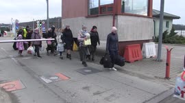 Hundreds fleeing Ukraine enter Poland through border crossing in Hrebenne