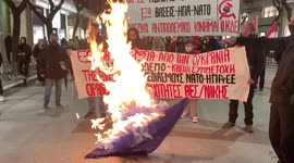 Protesters in Greece set flame to NATO flag during anti-war rally