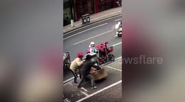 Bizarre moment two women fight over cardboard box in China