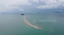 Beautiful beach with hidden sand walkway leads to another island in southern Thailand