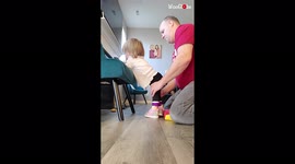 Determined dad helps partially paralysed daughter practise standing up