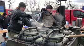 Polish bikers provide hot food to Ukrainian refugees near border