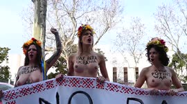 Feminist activists protest bare-chested against war in Ukraine in front of the Russian Embassy in Madrid