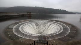 Stunning footage shows spillway in full flow after Britain was battered by heavy rainfall