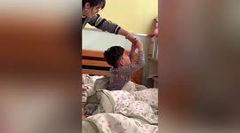 Kindergarten teacher gently puts sleepwalking boy to bed in China