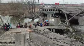 Residents of Irpin, near Kyiv, flee city through destroyed bridge