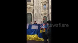 Prayer with candles during manifestation in support of Ukraine in Milan, Italy