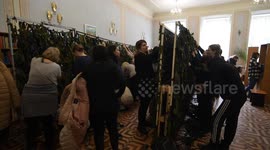 Women weave a camouflage net for the Ukrainian army in Lviv, Ukraine