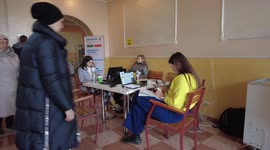 Ukrainian girl with her little dog waits at a Help Desk for displaced people at a Relief Work Coordination Center in the West Ukrainian city of Uzzhorod