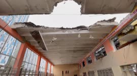 Ukrainian man shows Russian destruction at Karazin University's sports complex in Kharkiv