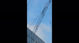 Daredevils scale crane at One Thames City, Nine Elms in south London, closing road in both directions