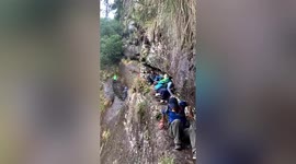 Backpacker rescued after sliding off cliff in China