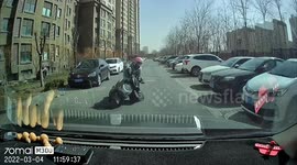 Chinese motorist helps delivery man lift scooter up after strong winds blow it over on road
