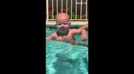 'Baby girl makes ludicrous face before diving underwater  
'