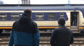 Ukraine: Man Waves Goodbye To Family Boarding On Train In Kyiv