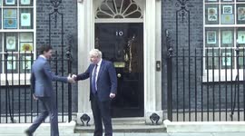 Boris Johnson awkwardly tries to give Justin Trudeau a fist bump but is rebuffed with handshake