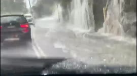 Australia: Roadside ‘Waterfall’ Forms As Heavy Rains, Flooding Hit Sydney And Suburbs