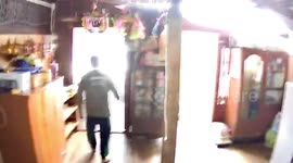 Shocked resident holds door for support as strong winds batter his home in Thailand