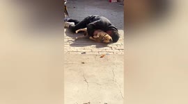Man spotted holding onto dog while asleep after drinking in China
