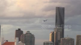 EA-18G “growler” fighter jet at eye level between skyscrapers