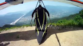 Takeoff fail sees hang glider pilot crash-land into trees below mountain in South Korea