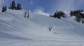 Crazy snowmobile jump fail sees rider plummet into the ground in Canada