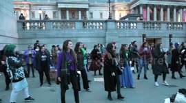 Security at Trafalgar Square move women practicing a dance from the Square on International Women's Day 2022