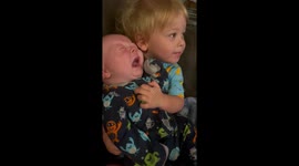 Older brother holding baby, giving kisses and baby starts crying GET THAT BABY