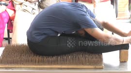 Nailed it! Mother and daughter do yoga poses on 2,555 nails in southern India