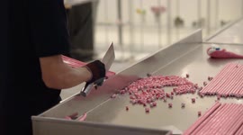 A man cuts rock candy with robotic speed and precision in a shopping centre in Bangkok. (new edit).