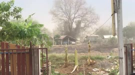 Strong wind tears off galvanised iron garage roof during storm in Thailand