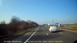 Van undertakes HGV at speed on the hardshoulder of the M56 narrowly missing a broken down car
