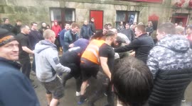 Players tackle each other in streets during rough hurling tradition in Cornwall, UK