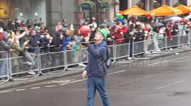 St Patrick's celebration cassida dick waving walking along in London