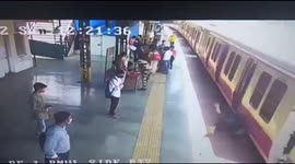 Dramatic moment an alert railway police official saves the life of a man who fell from a running train in western India