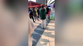 Chinese woman queuing for COVID-19 test uses tape measure to keep metre away from others