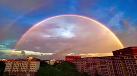 Spectacular perfect double rainbow forms in sky after heavy rain in Singapore