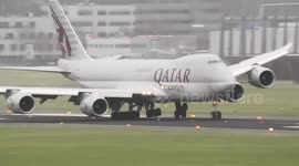 Hair-raising moment Qatar Airways jet navigates bumpy landing with its wheels lifting right off the tarmac