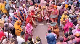 Women hit men with sticks during India's vibrant Lathmar Holi festival