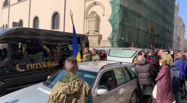 Air raid siren sounds during funeral procession held for soldiers in Lviv