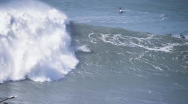 Spectacular 360 surf trick in massive wave in Nazare Portugal and jetski rescue