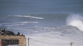 Surfer pro take a massive wave and wipeout with spectacular jetski rescue in Nazare