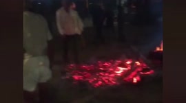 Devotees walk on burning embers during Holi celebrations in central India
