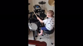 Toddler playing the Drums