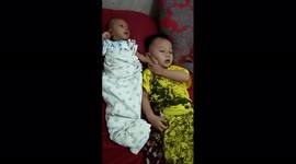 The Funny Action of a Two Year Old Child Parenting His One Month Old Sibling