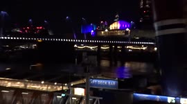 Royal Festival Hall glowing blue and yellow - view across the River Thames